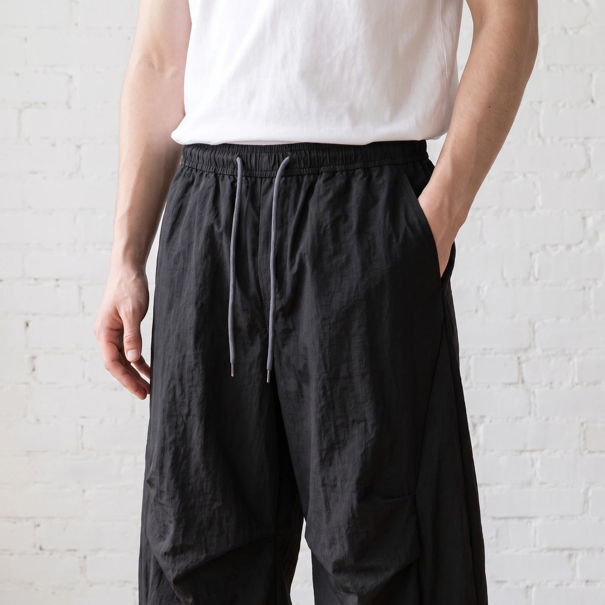 Man wearing the wide leg pants, hand in pocket, torso crop