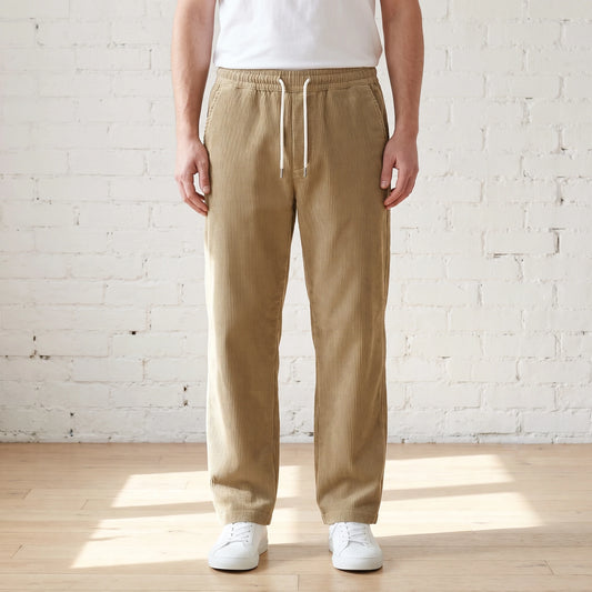 Khaki wide corduroy trousers with a white drawstring worn with a white tee and sneakers