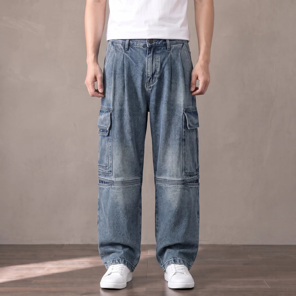 Mid blue washed baggy cargo jeans with big thigh pockets worn with a white tee and sneakers