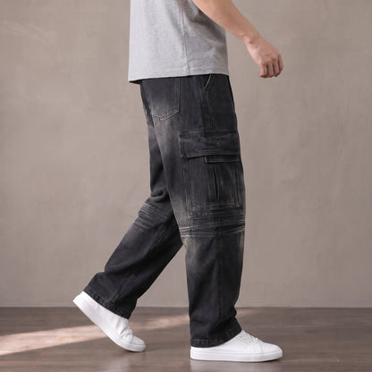 Man walking in the black washed baggy cargo jeans with a grey tee and white sneakers