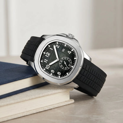 Black strap sport watch with a bold silver case on a book stack