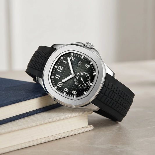 Black strap sport watch with a bold silver case on a book stack