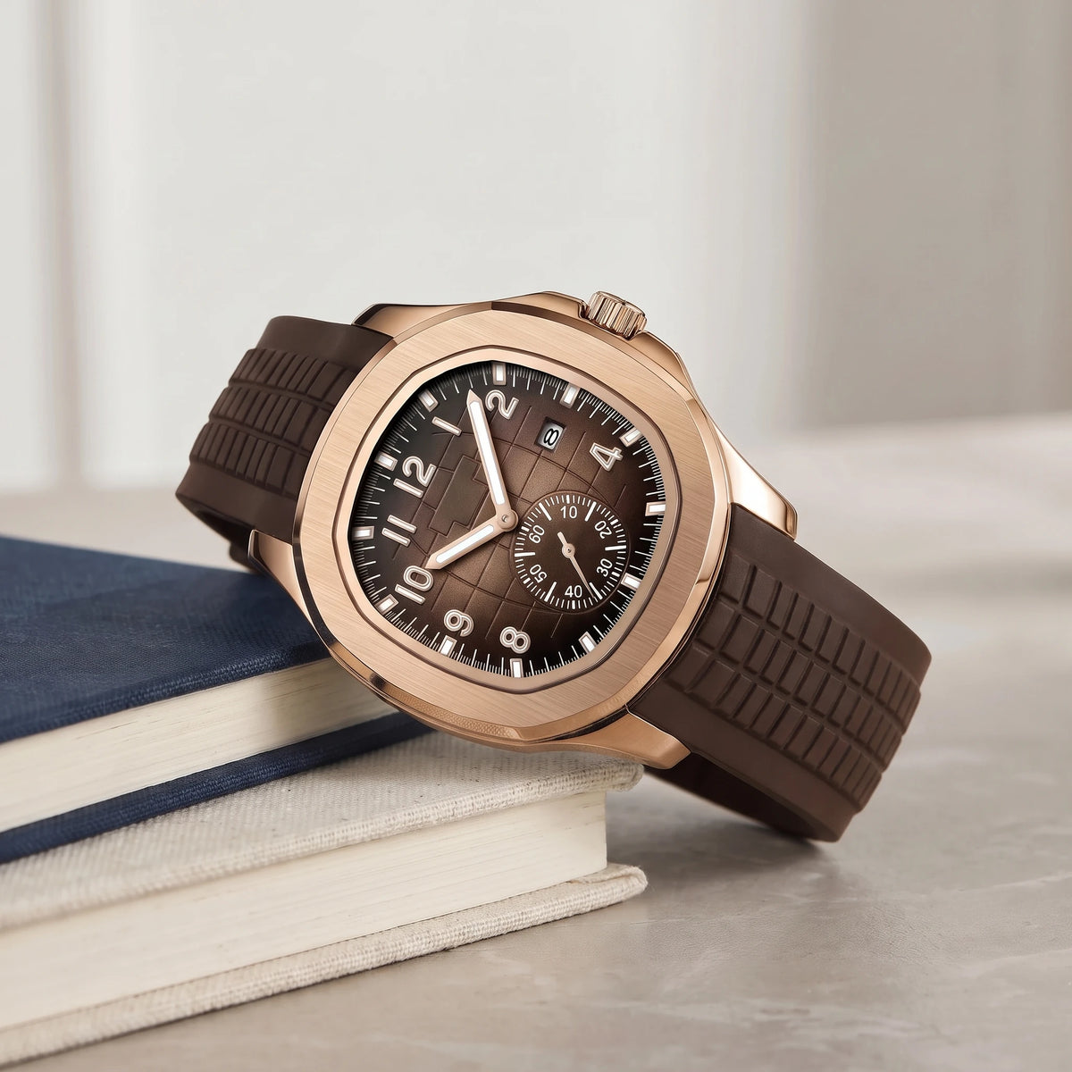 Brown strap sport watch with a rose gold case on a book stack