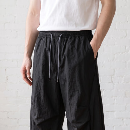 Man wearing the wide leg pants, hand in pocket, torso crop