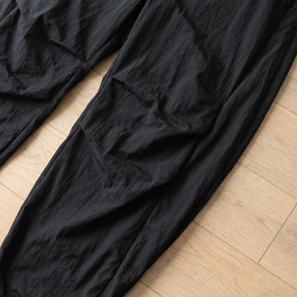 Close-up of the gathered knee pleats on the wide leg