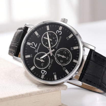 Close-up of the black dial, crown and lug on a silver-tone quartz watch