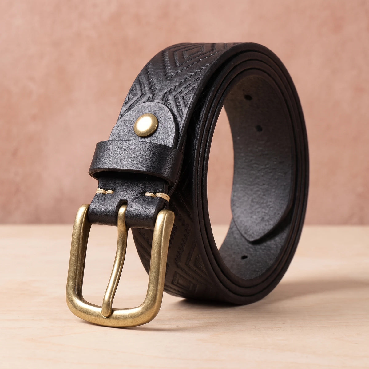 Black leather belt with embossed diamond pattern and brass pin buckle