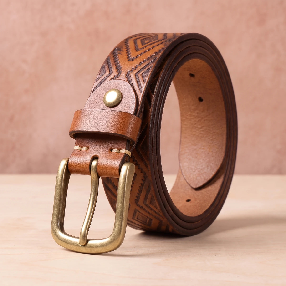 Tan leather belt with embossed diamond pattern and brass pin buckle