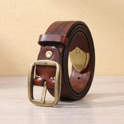 Brown leather belt with feather pattern embossing, brass pin buckle and brass shield tip