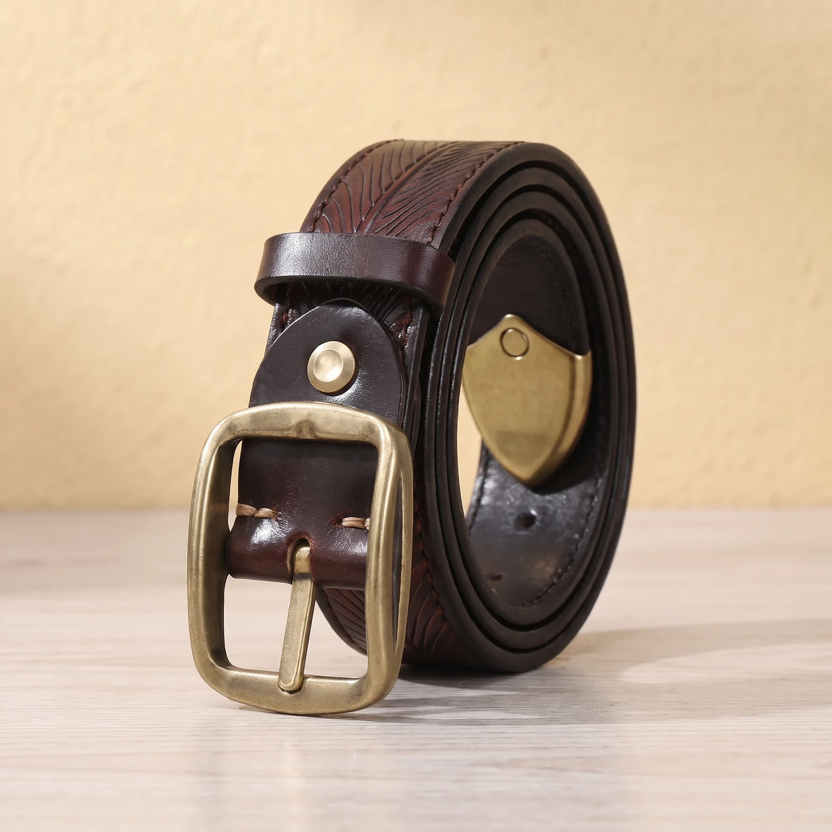 Coffee leather belt with feather pattern embossing, brass pin buckle and brass shield tip