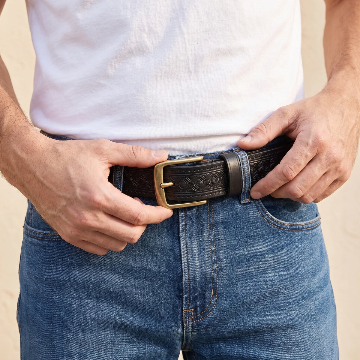 Man wearing the black embossed belt with jeans
