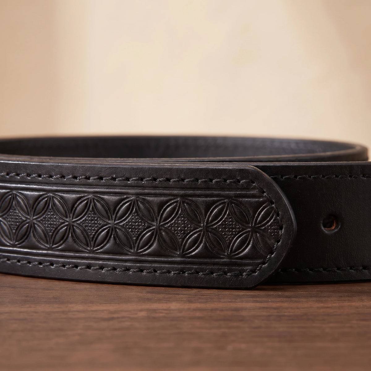 Close-up of the floral embossed strap and stitching
