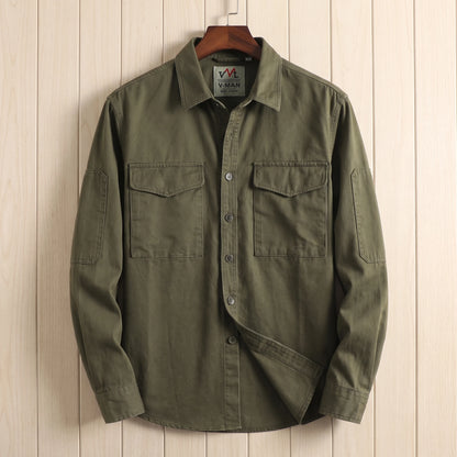 Green heavy cotton overshirt with two flap chest pockets hanging on a wooden hanger