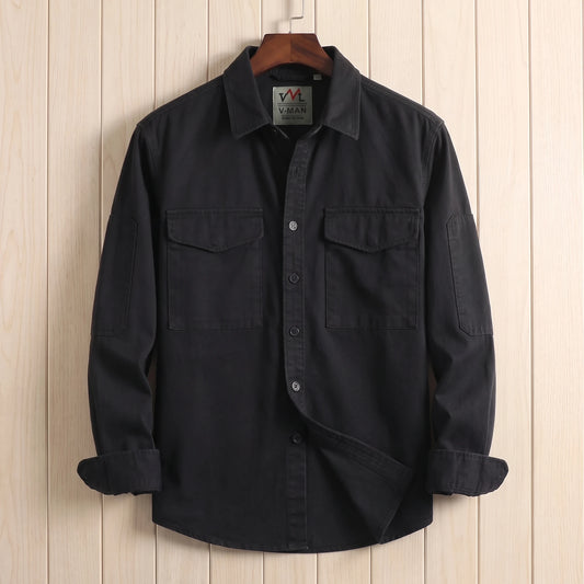 Black heavy cotton overshirt with two flap chest pockets hanging on a wooden hanger