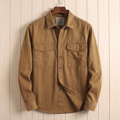 Brown heavy cotton overshirt with two flap chest pockets hanging on a wooden hanger