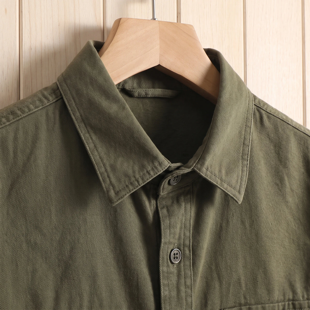 Close-up of the collar and buttons on a green thick cotton twill overshirt