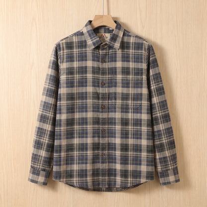 Blue heavy cotton plaid shirt with a chest pocket hanging on a wooden hanger