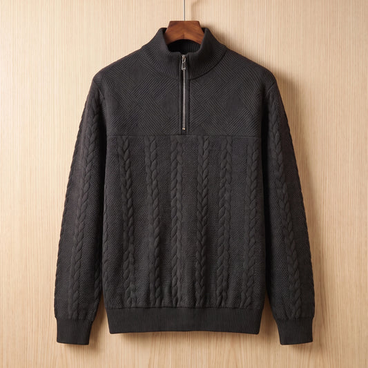 Black jacquard half zip sweater with a tall collar and cable panel hanging on a wooden hanger