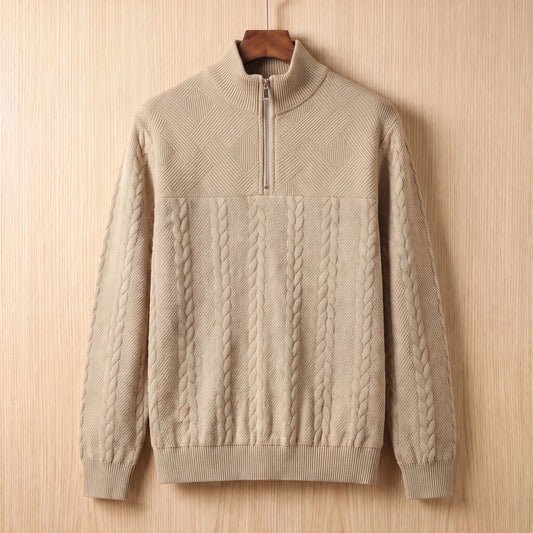 Khaki jacquard half zip sweater with a tall collar and cable panel hanging on a wooden hanger