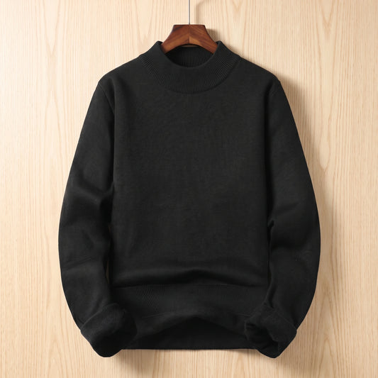 Black mock neck sweater with folded cuffs showing fleece lining hanging on a wooden hanger