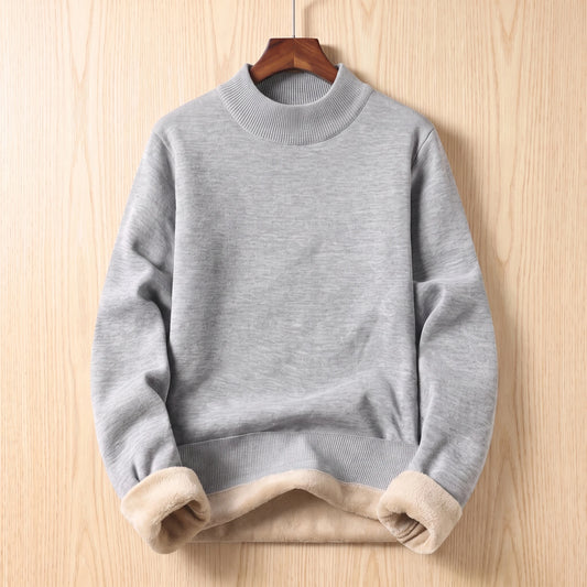 Grey mock neck sweater with folded cuffs showing fleece lining hanging on a wooden hanger