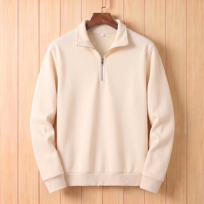 Cream half zip sweater with a folded collar and ribbed cuffs hanging on a wooden hanger