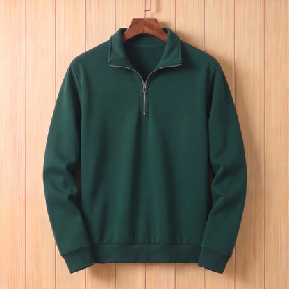 Dark green half zip sweater with a folded collar and ribbed cuffs hanging on a wooden hanger