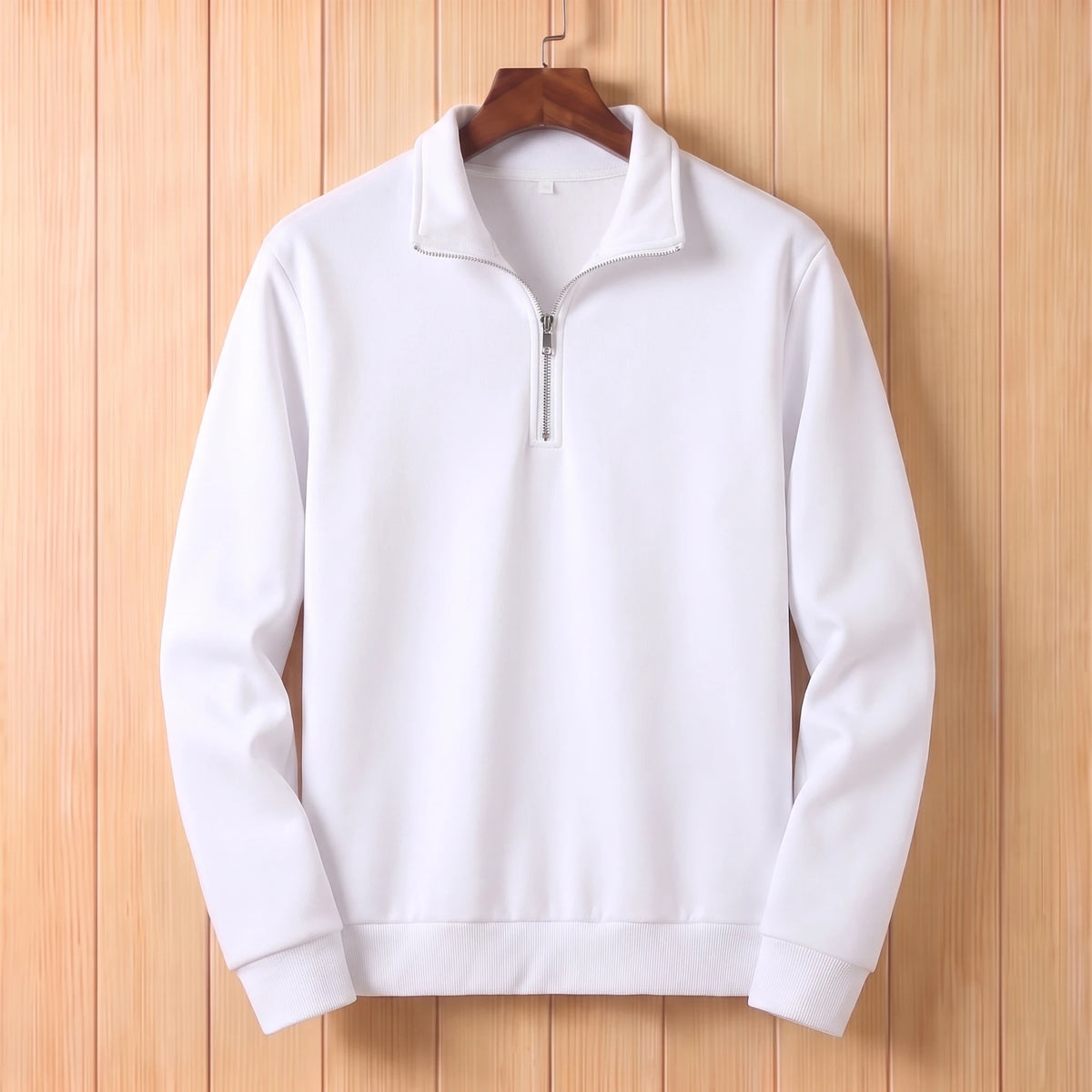 White half zip sweater with a folded collar and ribbed cuffs hanging on a wooden hanger