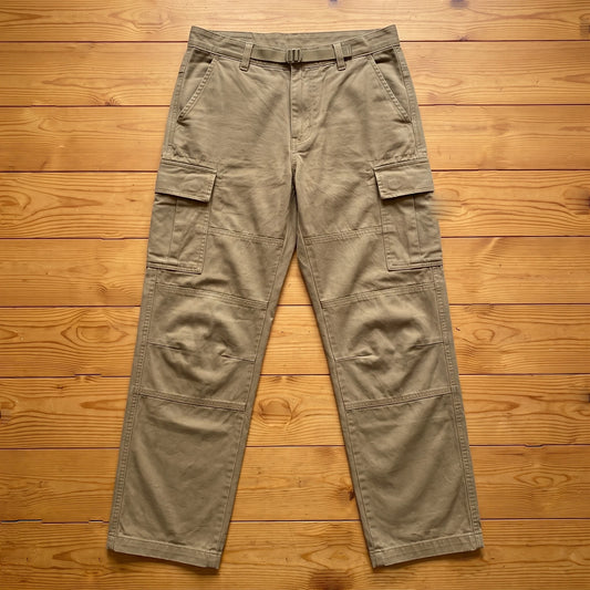 Khaki relaxed cargo trousers laid flat on pine wood