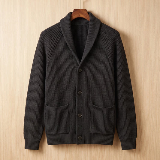 Black ribbed knit cardigan with two patch pockets hanging on a wooden hanger