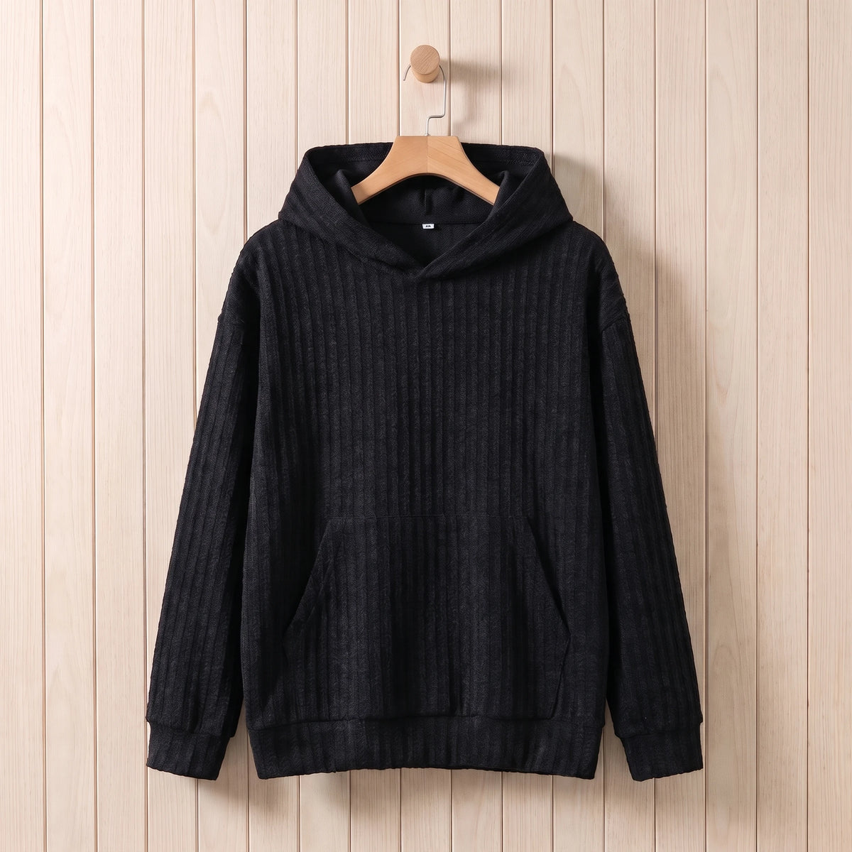 Men's dark grey ribbed knit hooded sweater hanging on a wooden hanger