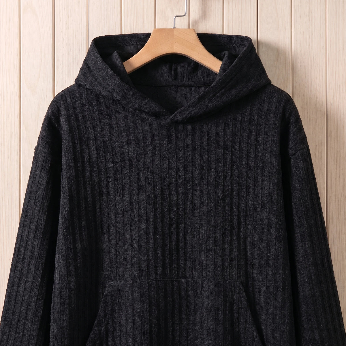 Close-up of the hood and front pocket on the black knit hooded sweater