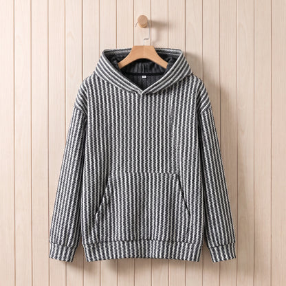 Men's black and white striped knit hooded sweater hanging on a wooden hanger