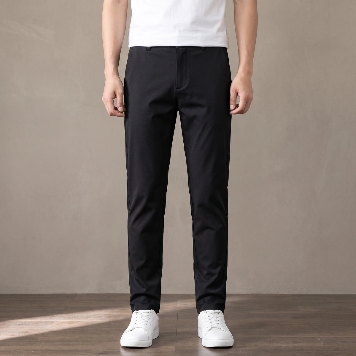 black slim stretch trousers worn with a white tee and white trainers