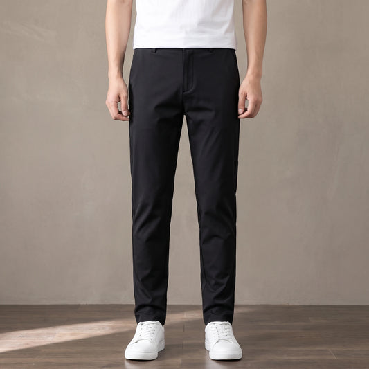 black slim stretch trousers worn with a white tee and white trainers