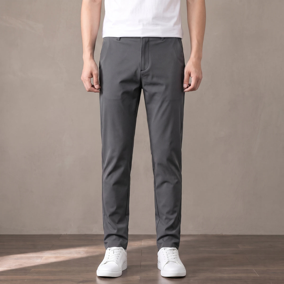 dark grey slim stretch trousers worn with a white tee and white trainers