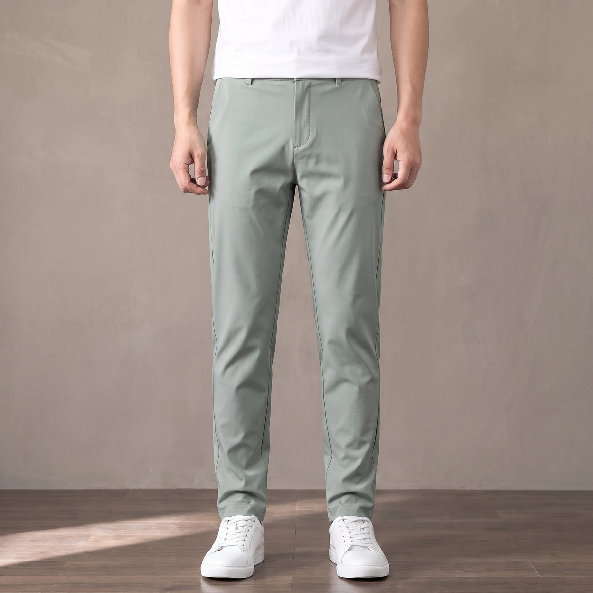 light green slim stretch trousers worn with a white tee and white trainers