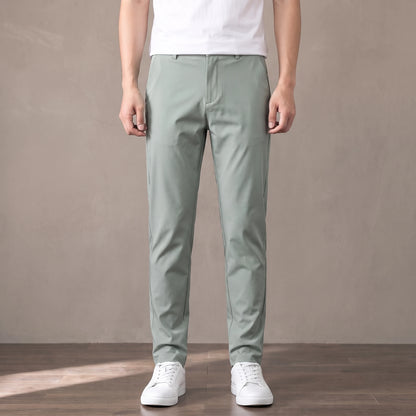 light green slim stretch trousers worn with a white tee and white trainers