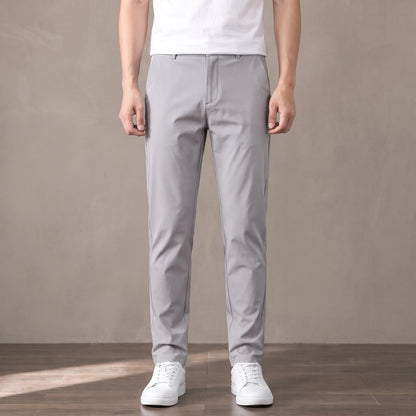 light grey slim stretch trousers worn with a white tee and white trainers
