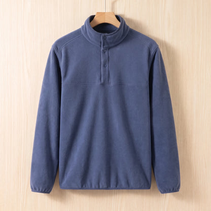 Blue fleece pullover with a snap collar and elastic cuffs hanging on a wooden hanger