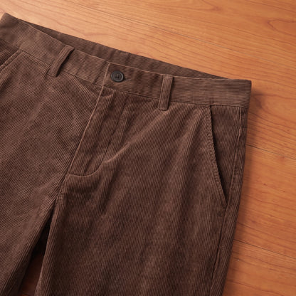Close-up of the waistband, belt loops and pocket on brown corduroy trousers