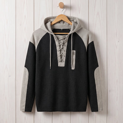 Men's black waffle knit lace-up hooded sweater hanging on a wooden hanger