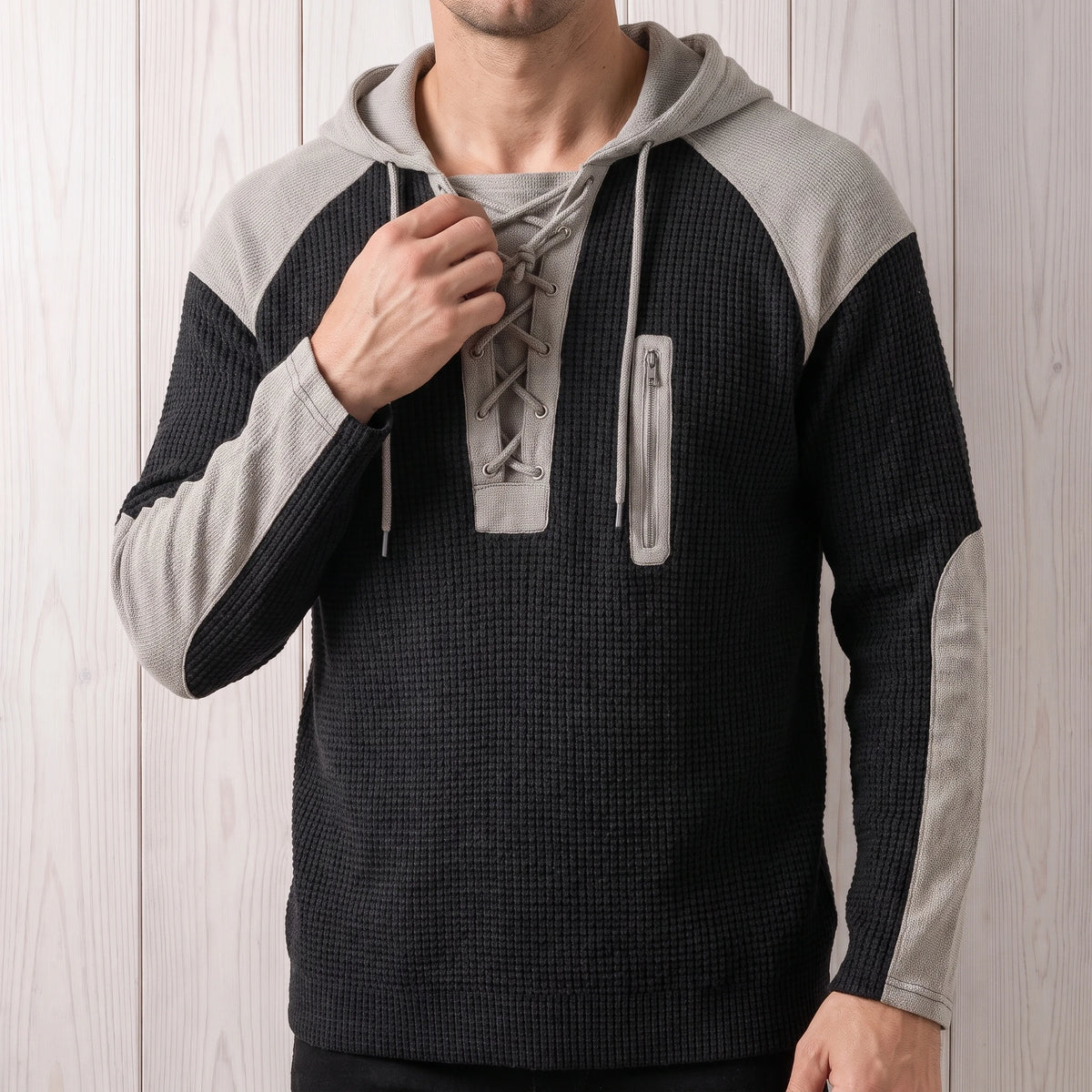 Man wearing the black waffle knit lace-up hooded sweater