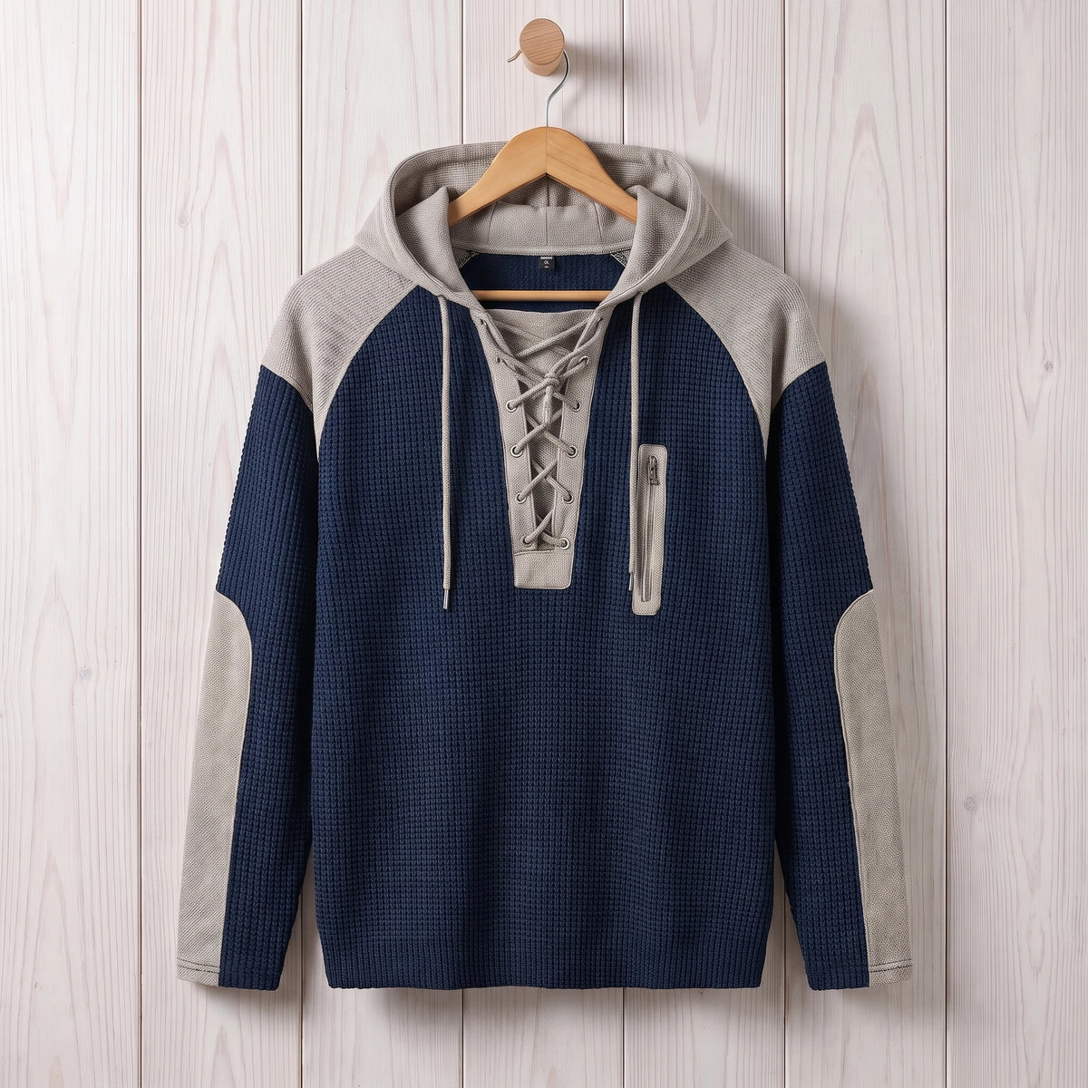 Men's navy blue waffle knit lace-up hooded sweater hanging on a wooden hanger