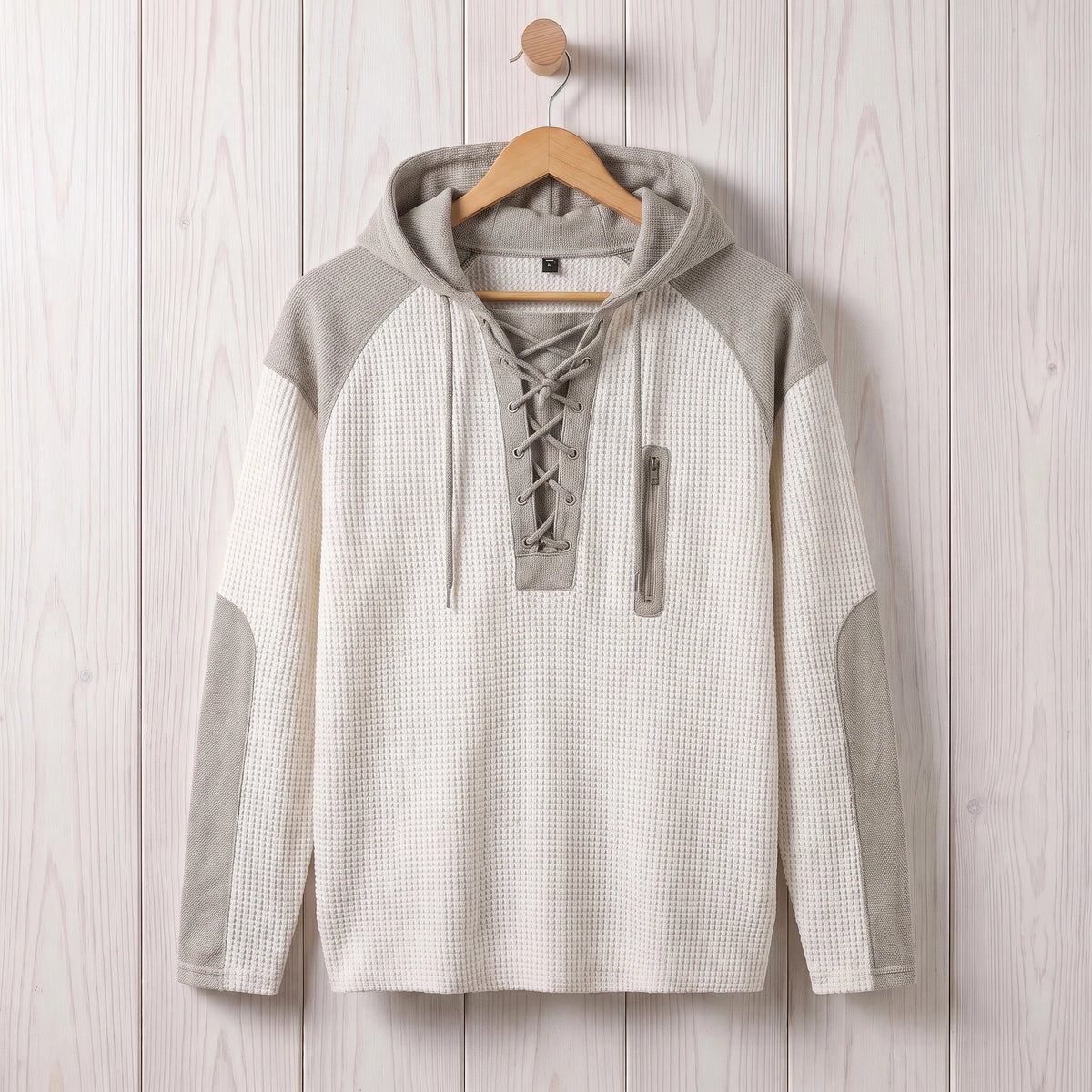 Men's white waffle knit lace-up hooded sweater hanging on a wooden hanger