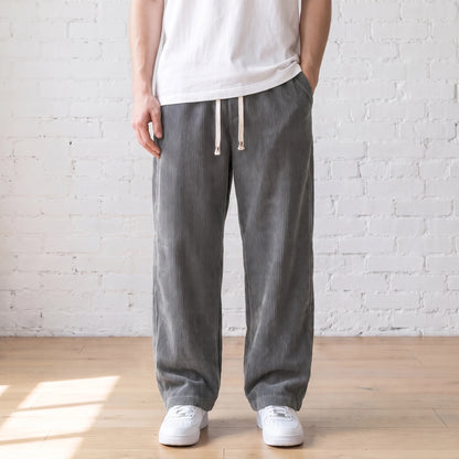Grey wide corduroy trousers with a white drawstring worn with a white tee and sneakers