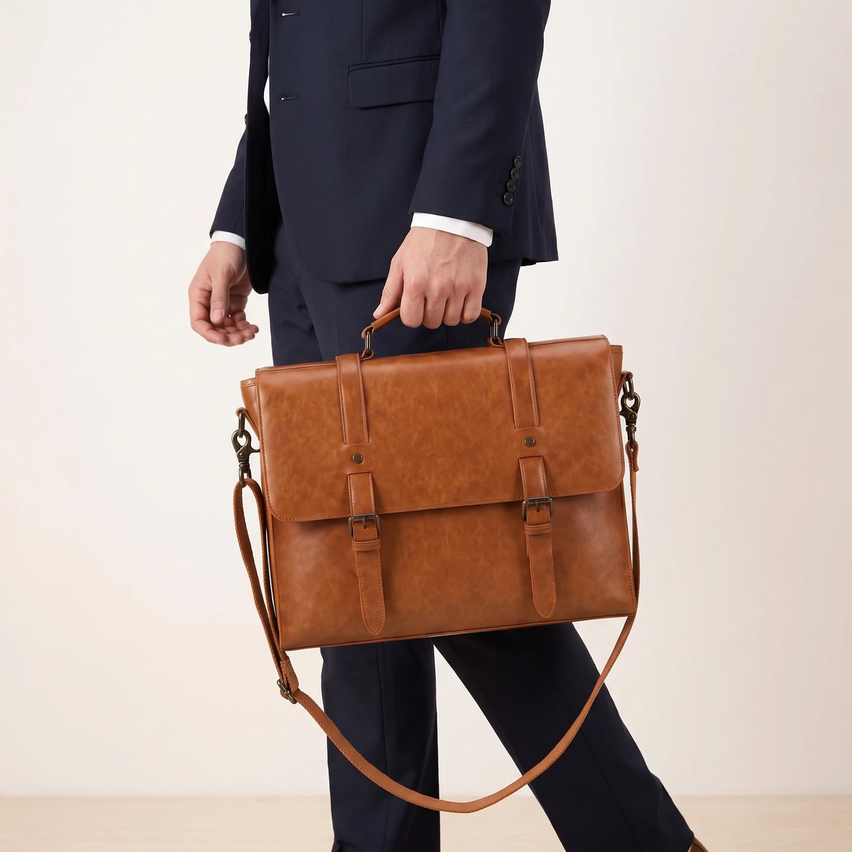BUCKLE FLAP MESSENGER BAG carried by the handle