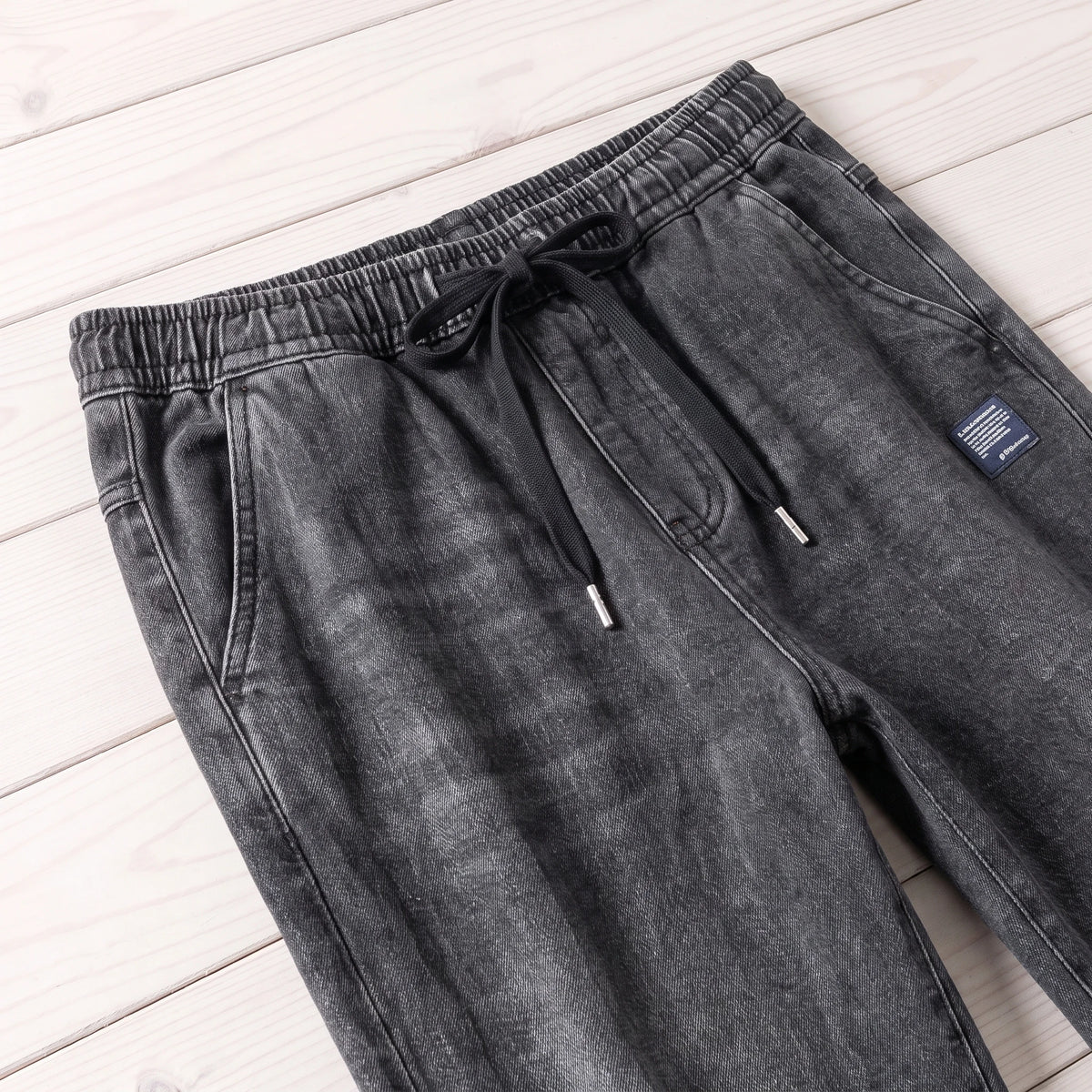 FADED DENIM JOGGERS waistband and drawcord close-up
