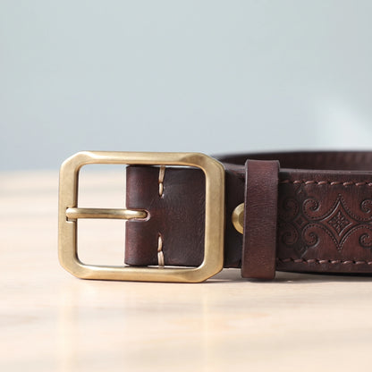 EMBOSSED COWHIDE BELT brass buckle close-up